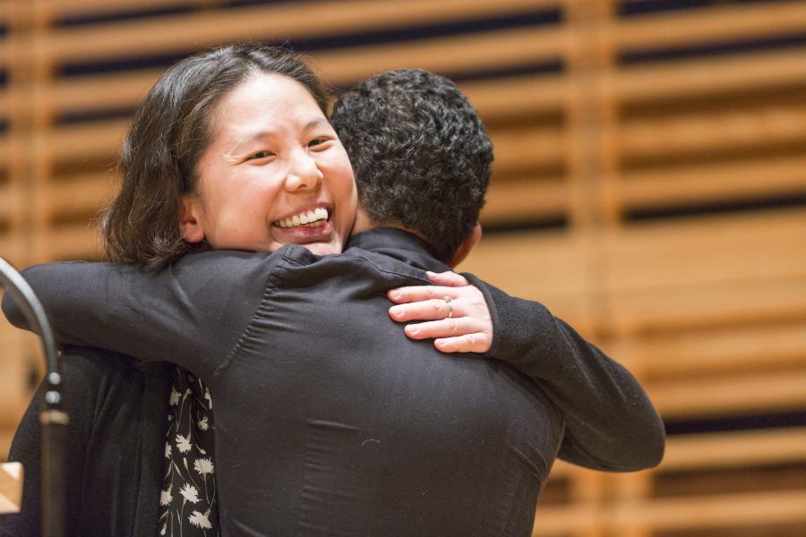 Students hug at Awards Ceremony