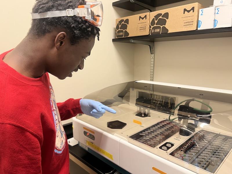 Student pointing at nutrient analyzer